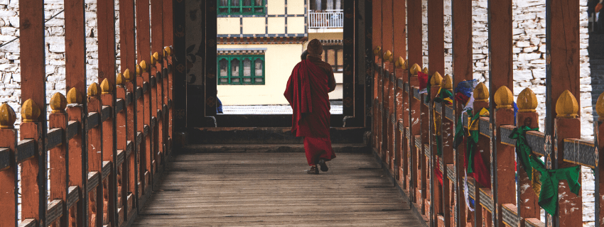 Monk on bridge Bhutan 